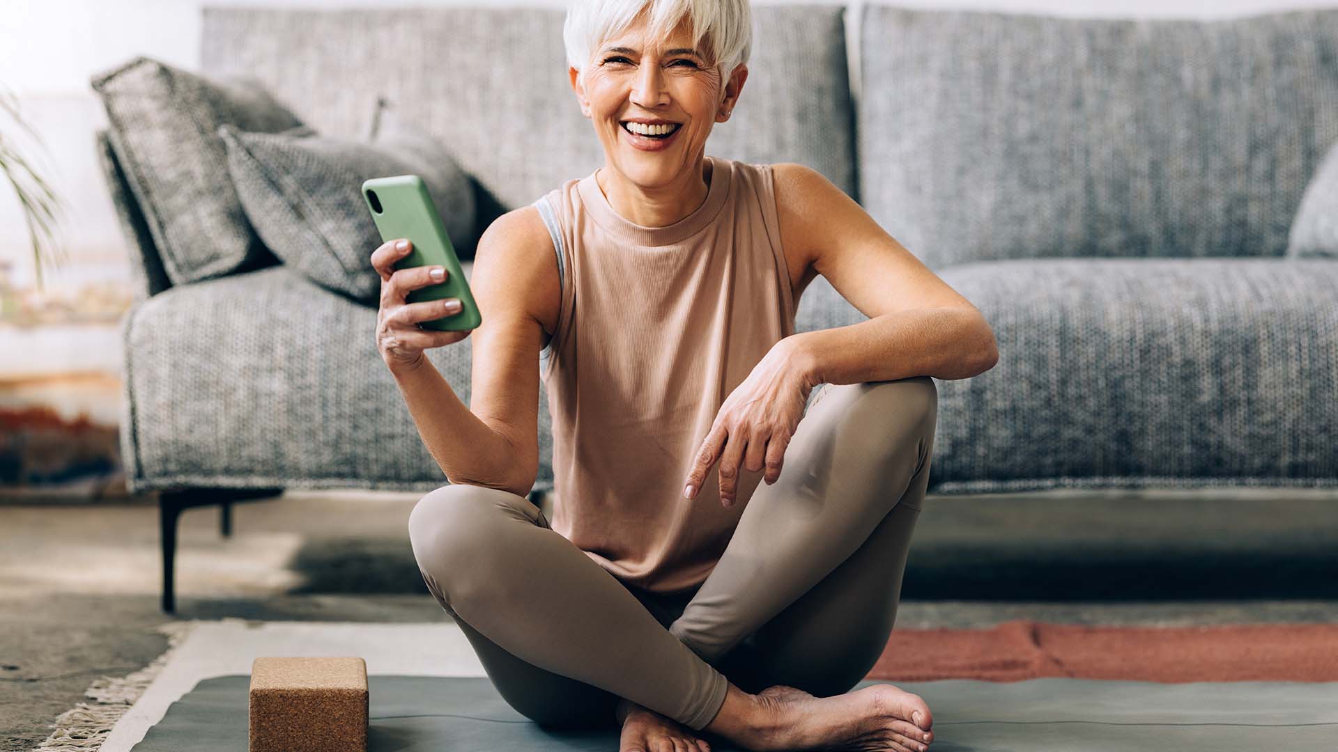 Woman sitting on floor with smartphone