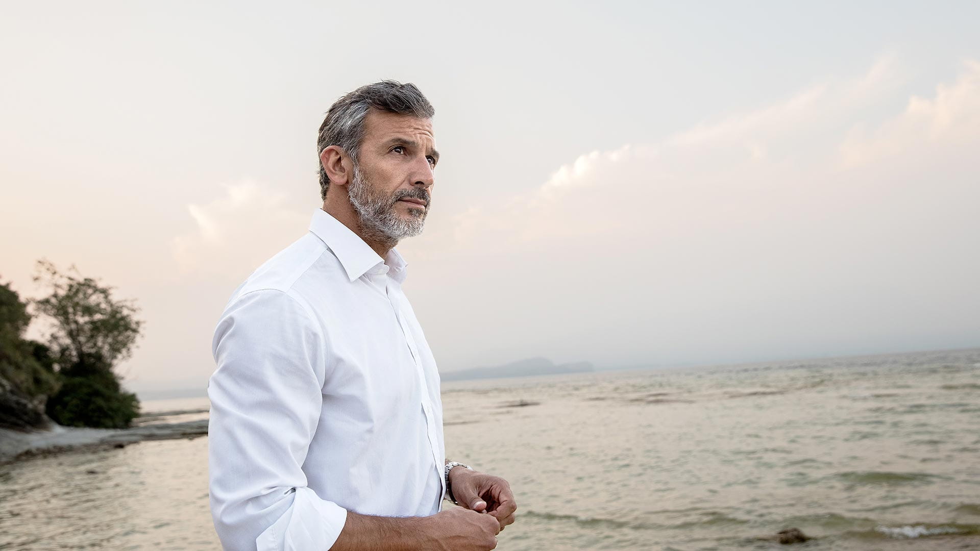 Man with Evoke hearing aids standing on beach